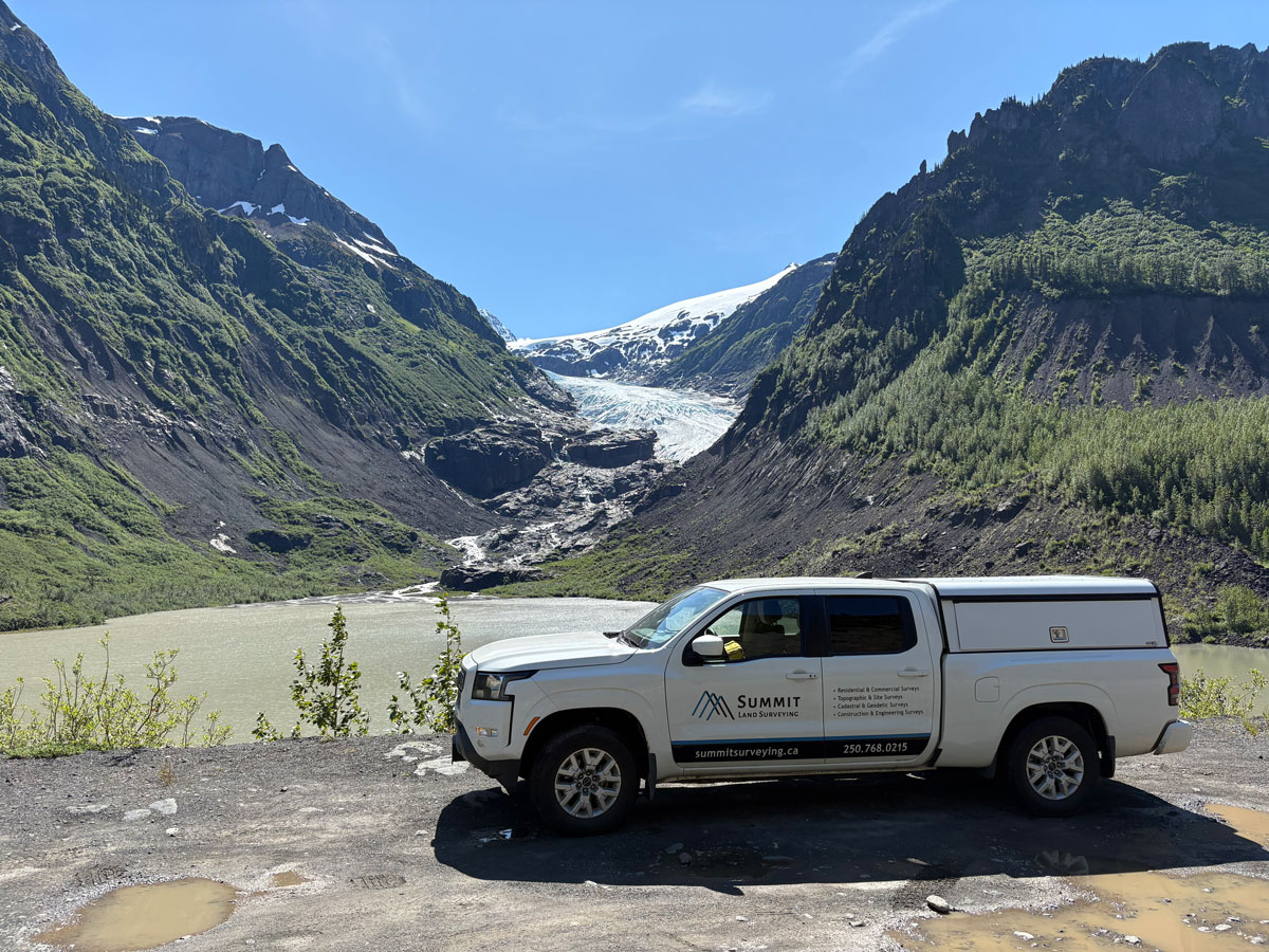 White truck, survey gear, mountains